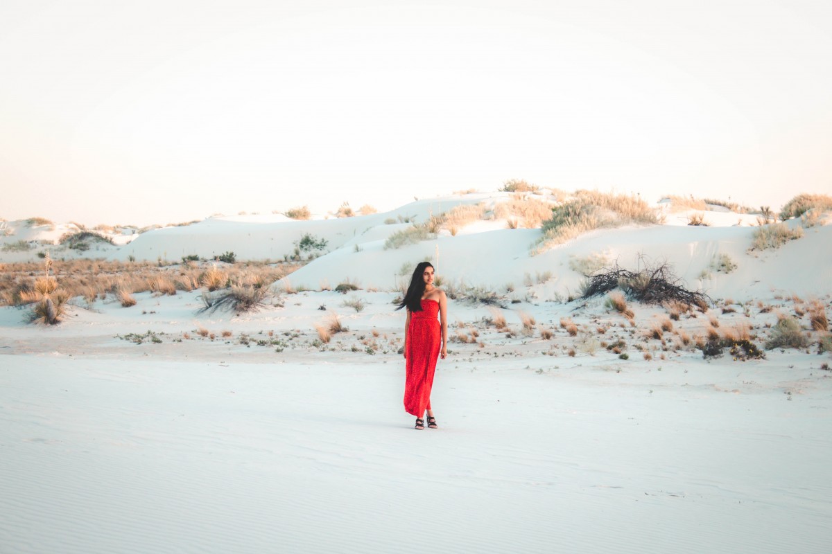girl in red dress visiting White Sands National Monument