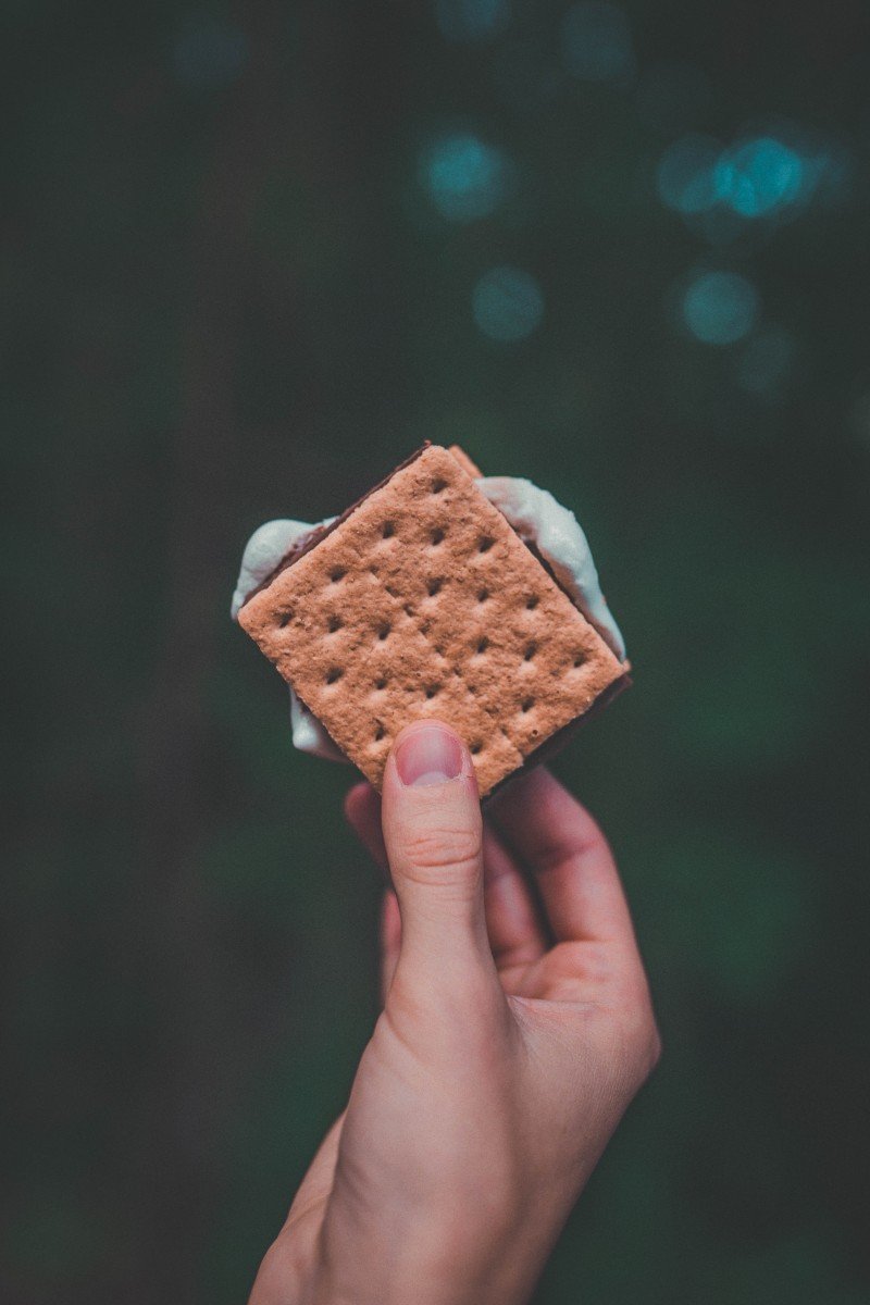 holding smores to include in your camping food checklist
