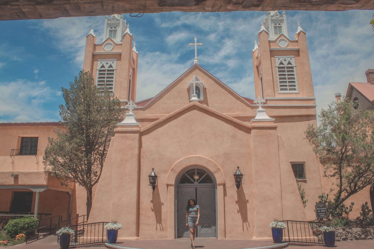 girl walking in front of San Felipe De Neri Church