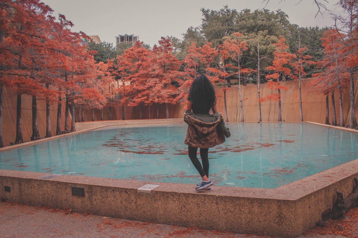 girl looking ahead in front of a clear blue Meditation Pool