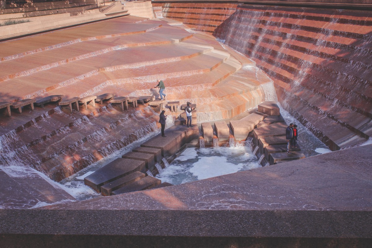 people walking towards the bottom of the Active Pool at the Fort Worth Water Gardens