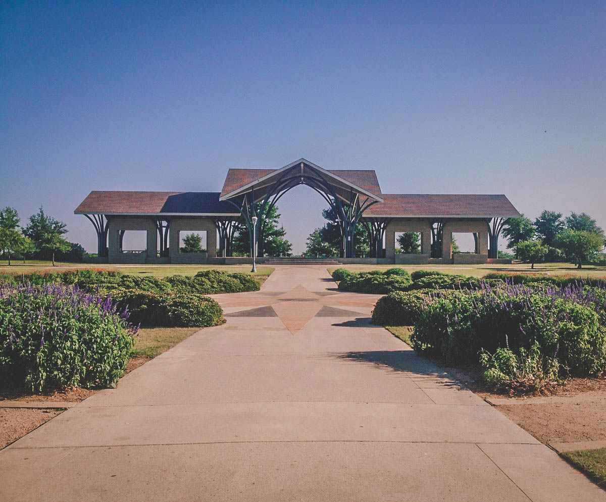 wide pathway (purple flowers along each side) leading up to a gazebo at Frisco Commons