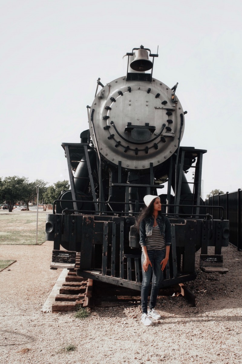 gawky awkward teenager in front of a train at the Frisco Heritage Museum