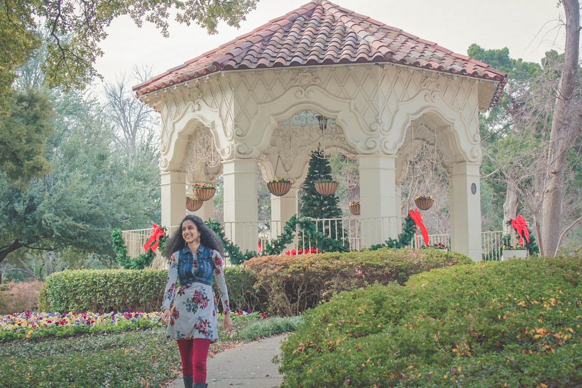 Anshula walking away from Dallas Flippen Park gazebo in winter (bows surrounding the gazebo)