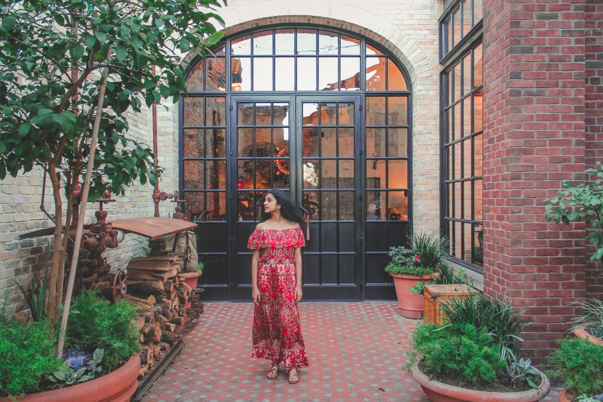 girl standing in front of Hotel Emma at The Pearl in San Antonio
