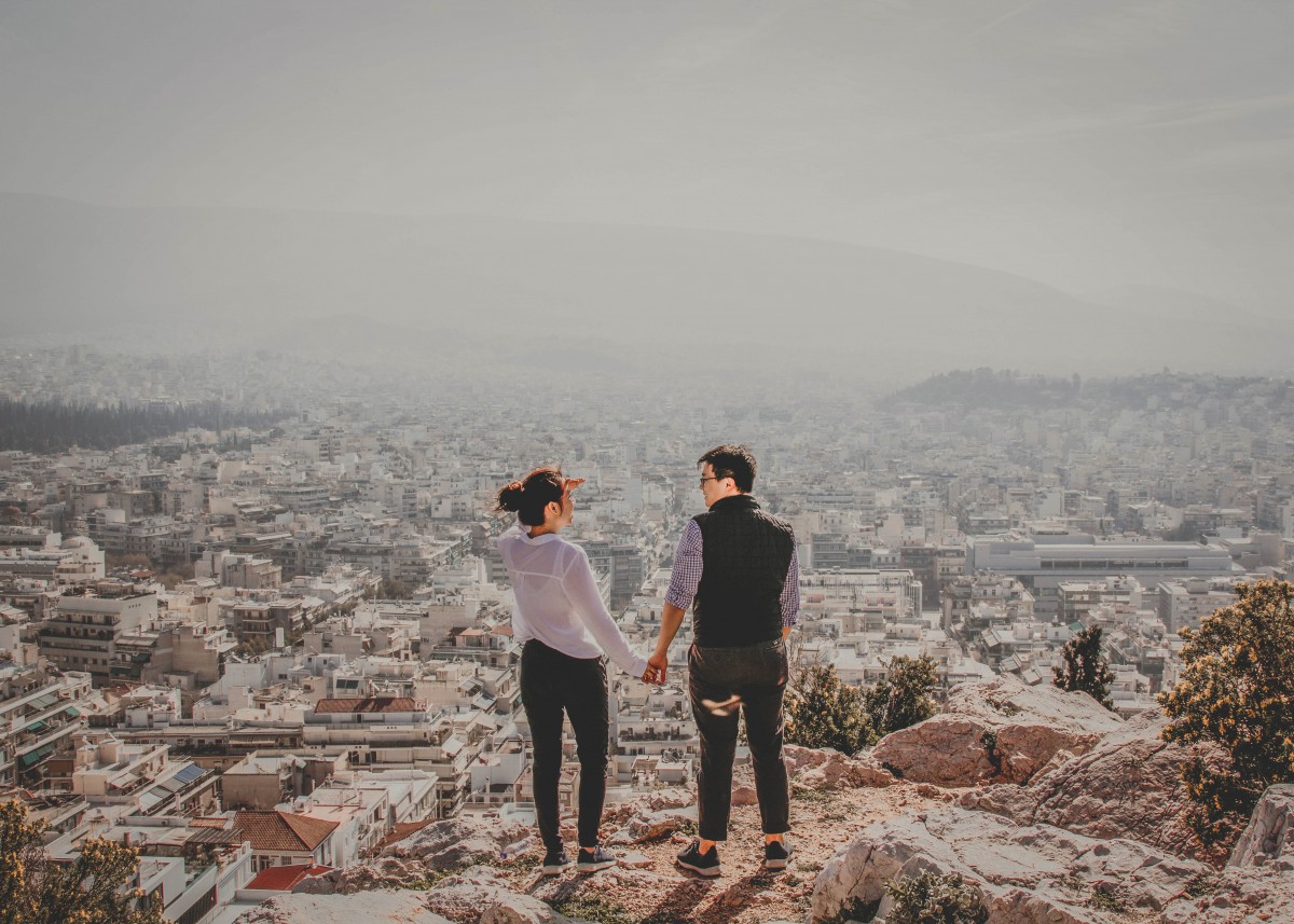 asian couple holding hands - road trip questions for couples