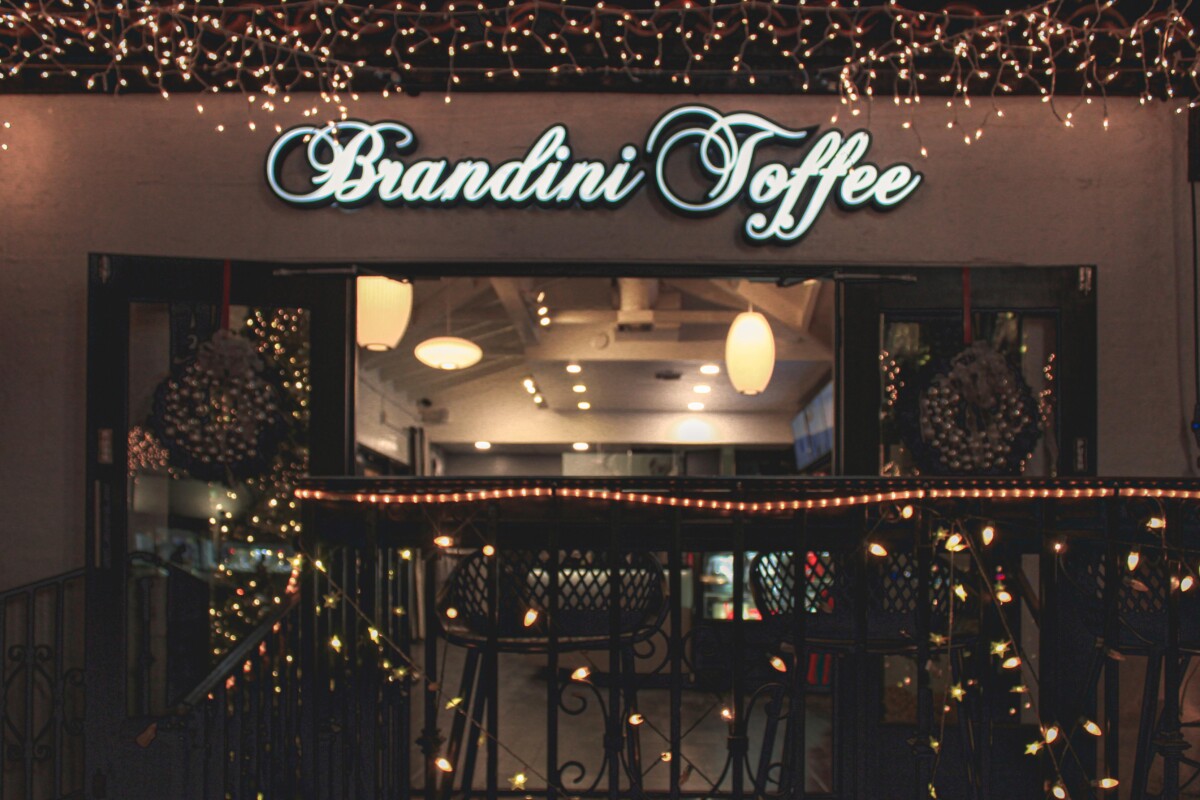 dessert in Palm Springs: lit up exterior of Brandini Toffee at night