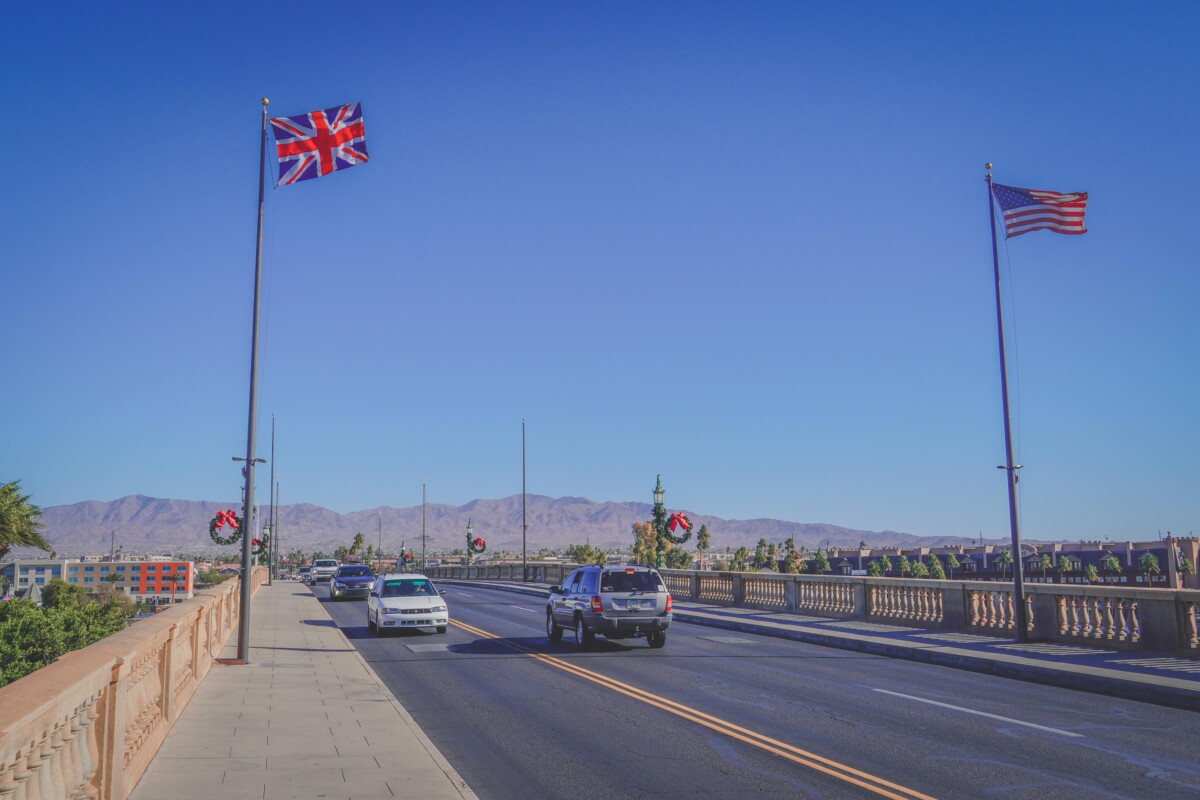 driving on a road with a British and American flag