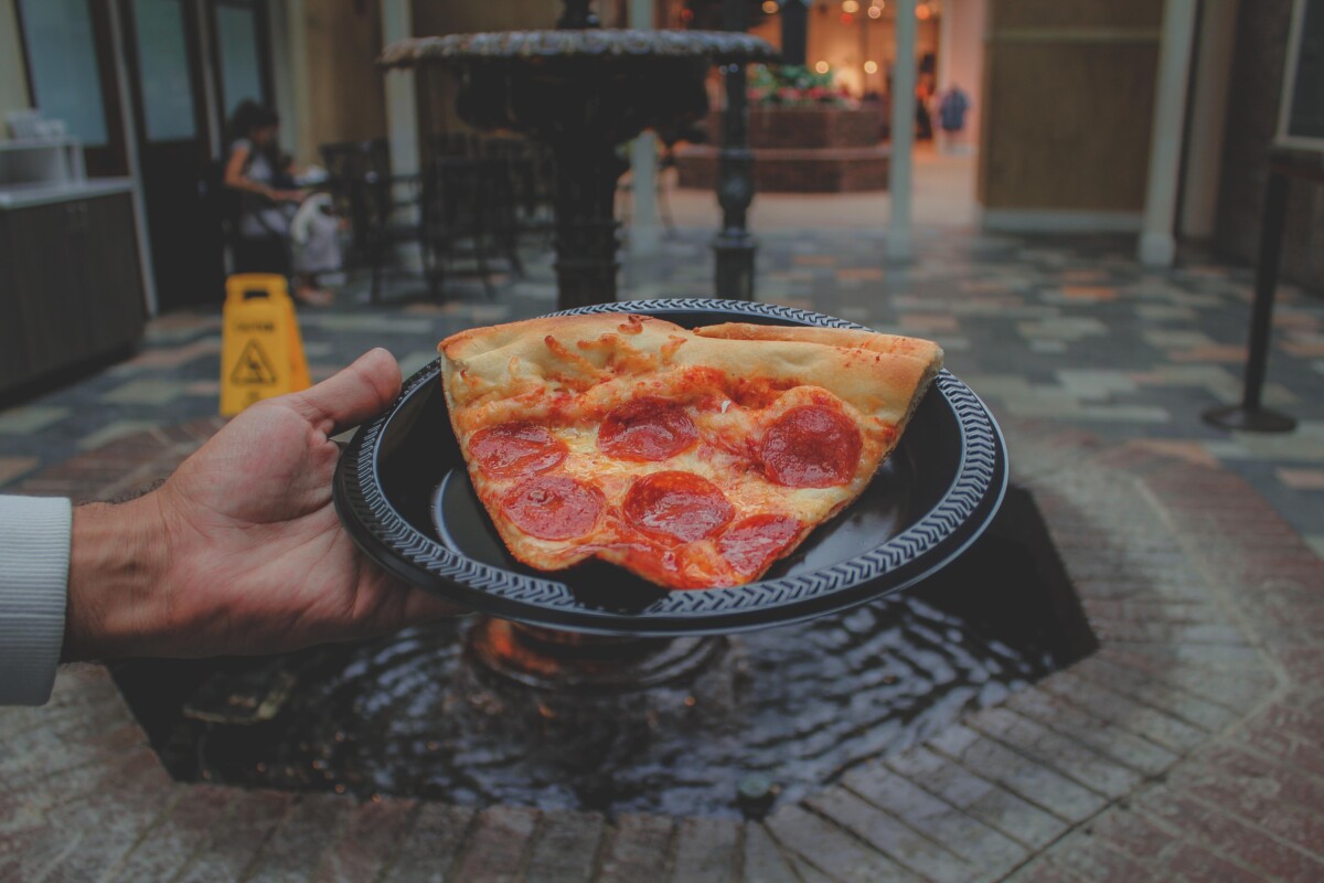 Best Opryland hotel restaurants: Paisano's Pizzaria & Vino pizza held up in front of a fountain