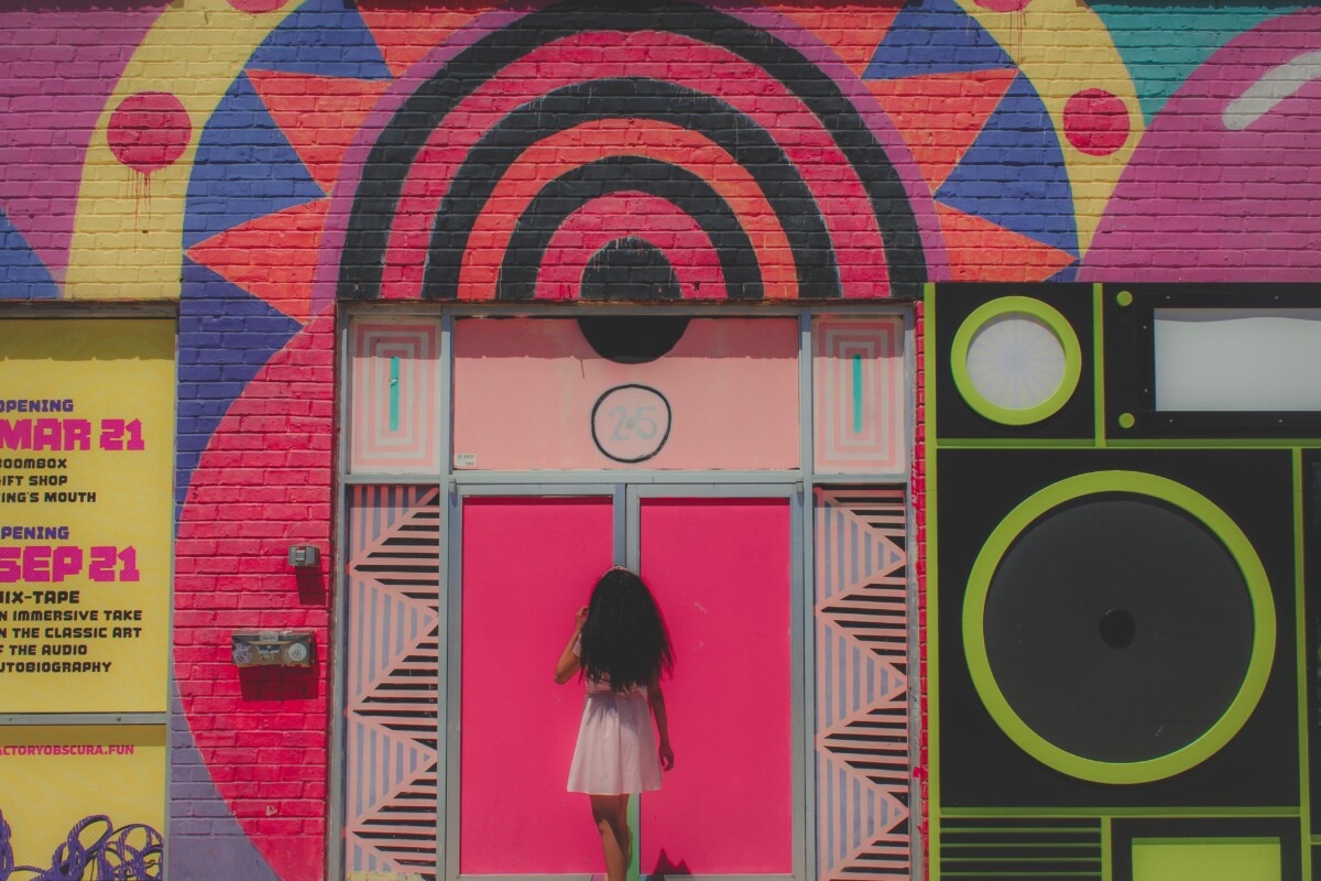 girl standing outside of a social media museum, one of the most modern types of museums