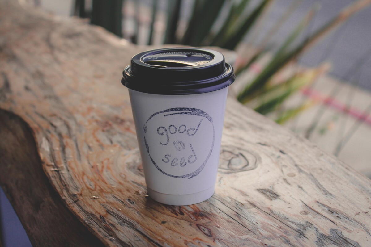 latte from Good Seed at wooden coffee counter bar outside of Good Seed Cafe