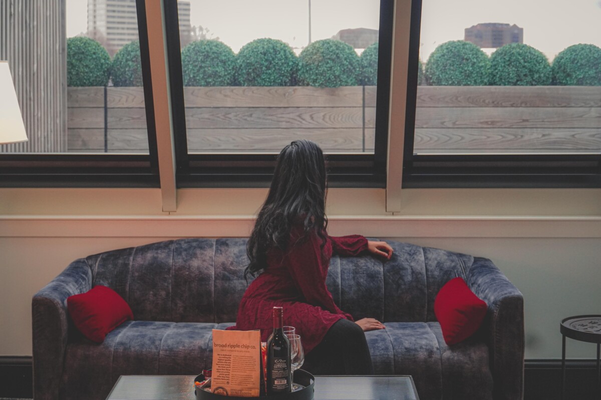 Anshula, editor in chief of Passport To Eden, looking out the skylight of Terrace King Room at the Bottleworks Hotel in Indianapolis