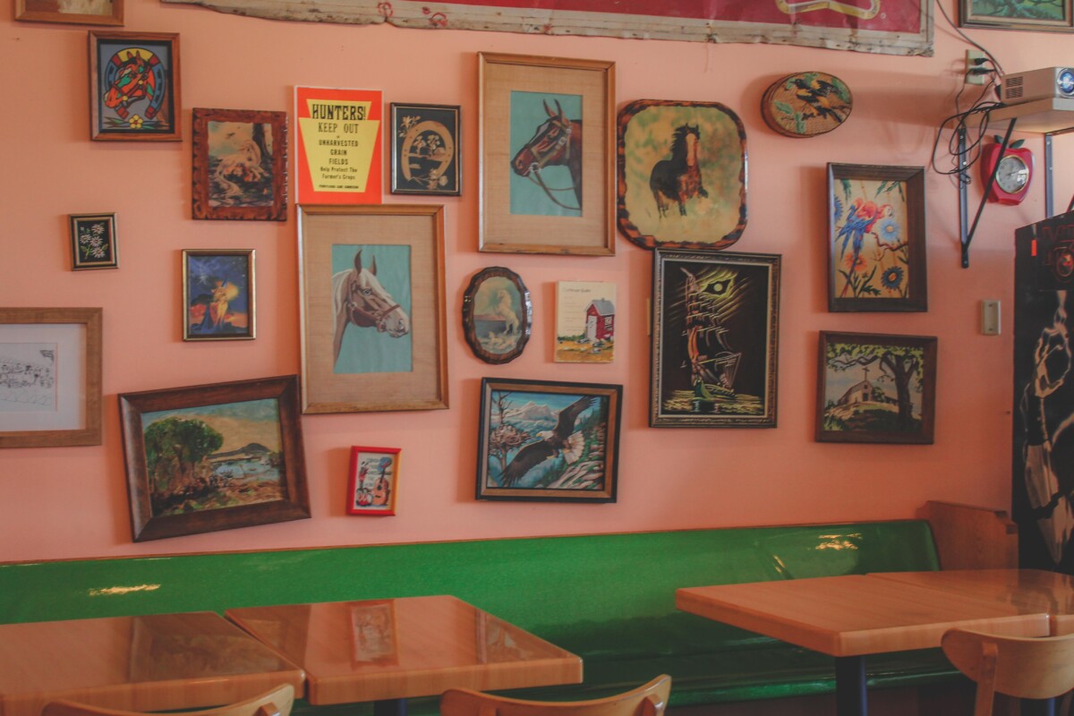 breakfast in Indianapolis: image of Love Handle Cafe gallery wall with horses and green booth