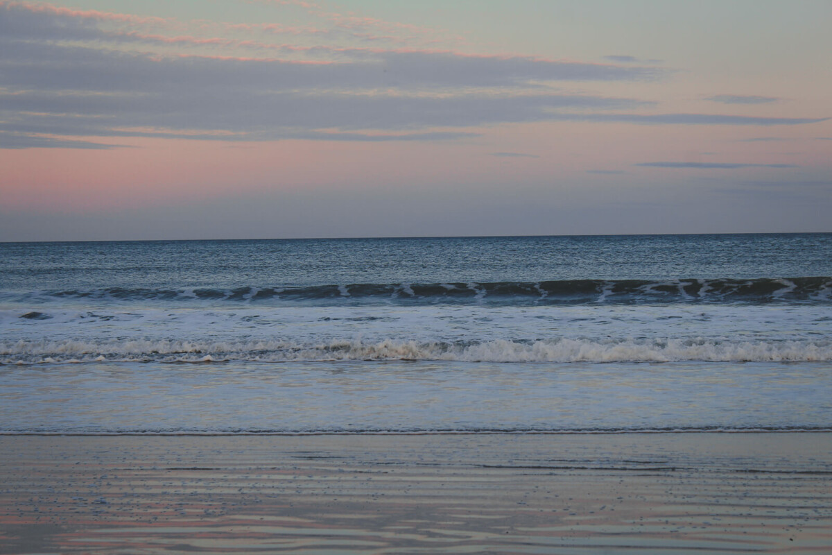Footbridge Beach in York Maine with waves slapping the ocean and sunset fading