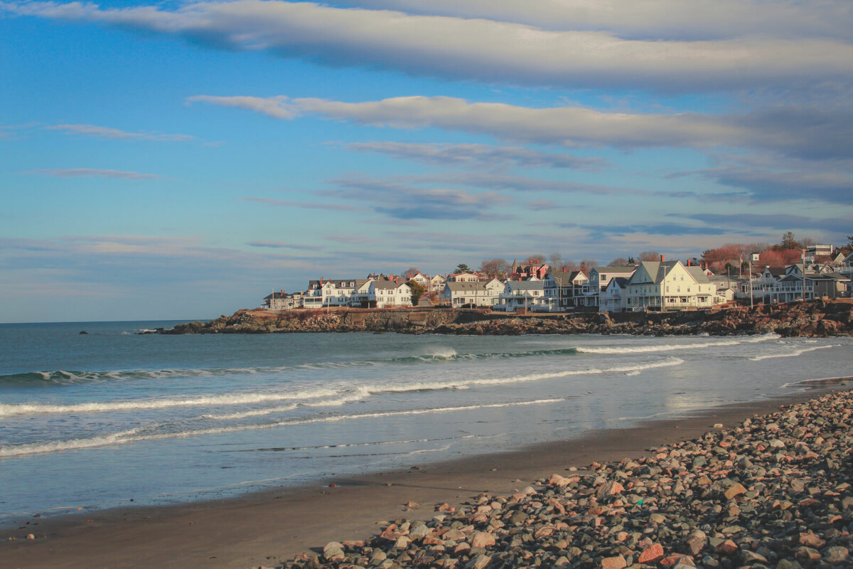 beautiful curve of Short Sands Beach facing hotels and holiday homes and Atlantic waves